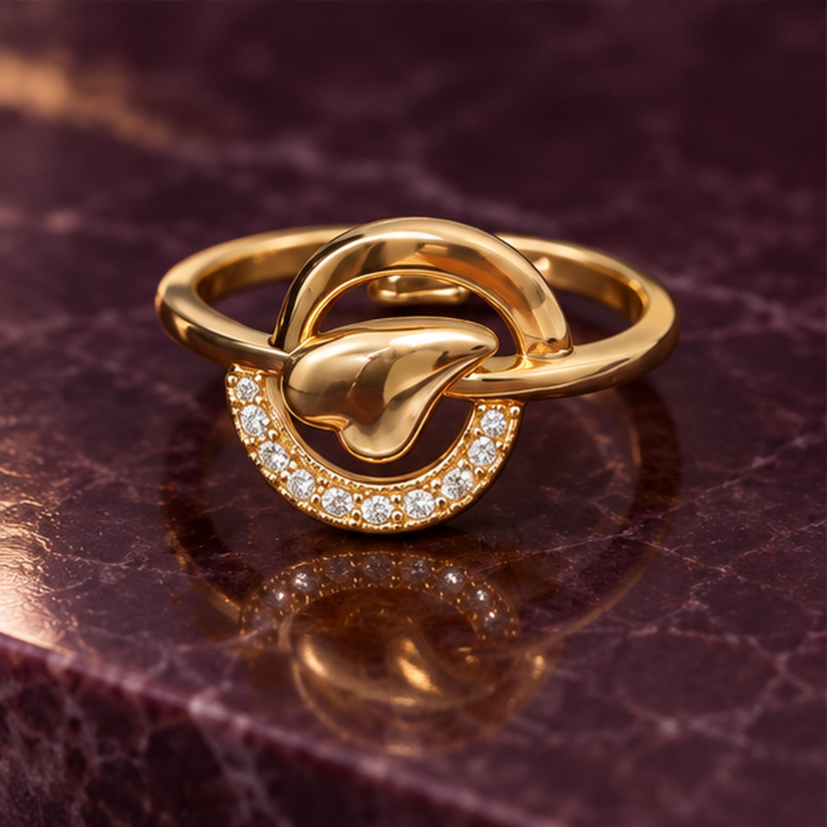 Aarohi Sculpted Orbit Sparkle Gold-Tone Ring on an aubergine stone backdrop