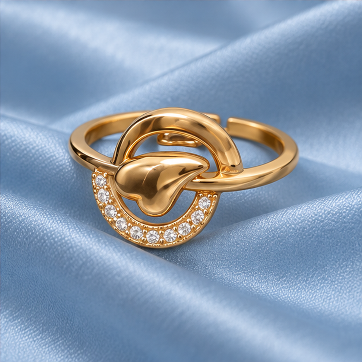 Aarohi Sculpted Orbit Sparkle Gold-Tone Ring on a powder blue satin backdrop