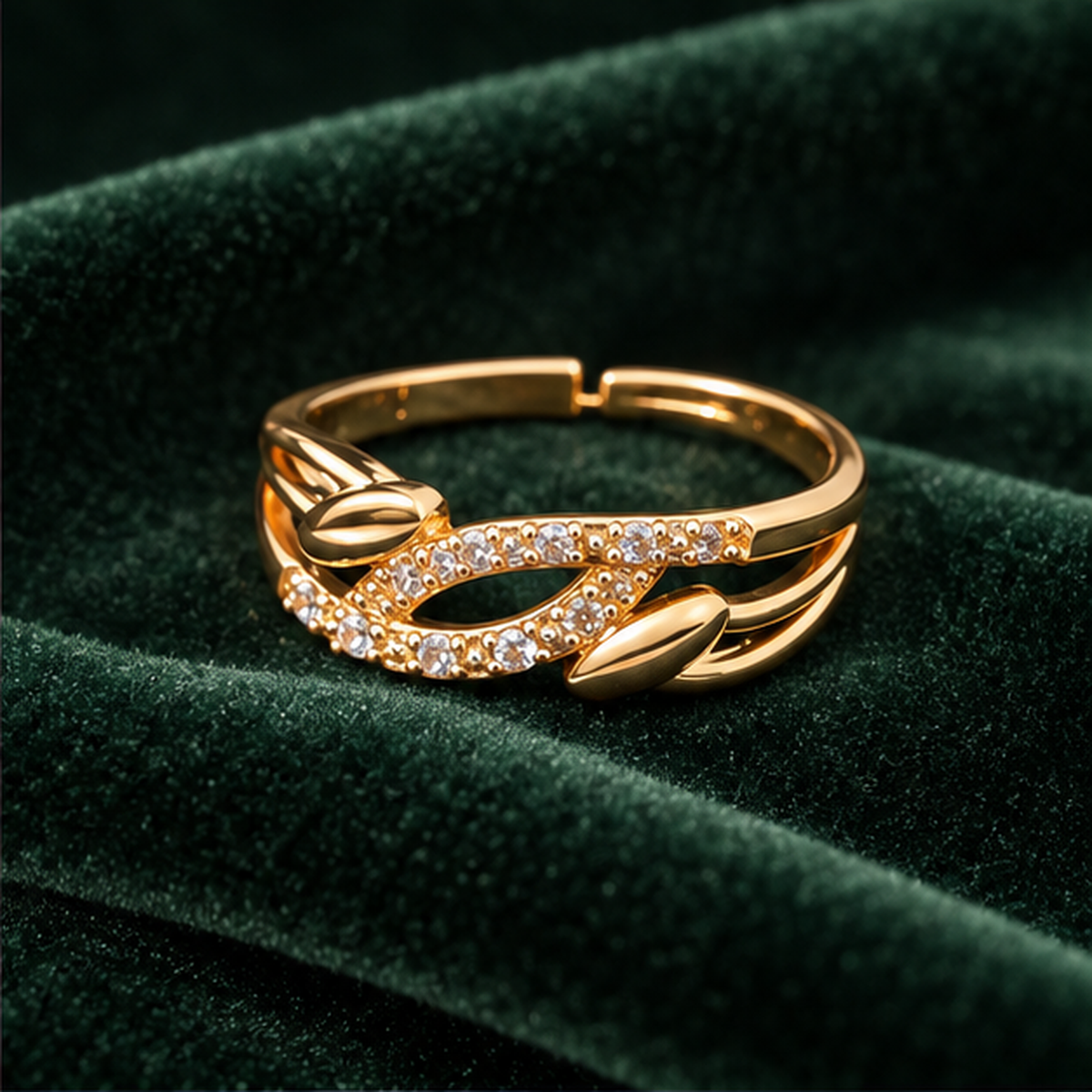 Ananta Leaf Infinity Sparkle Gold-Tone Ring on a forest green velvet backdrop