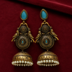 Mayur Neel Antique Peacock Jhumka Earrings on a ruby velvet backdrop