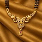 Morini Twin Peacock Gold-Tone Mangalsutra on a mustard ochre silk backdrop