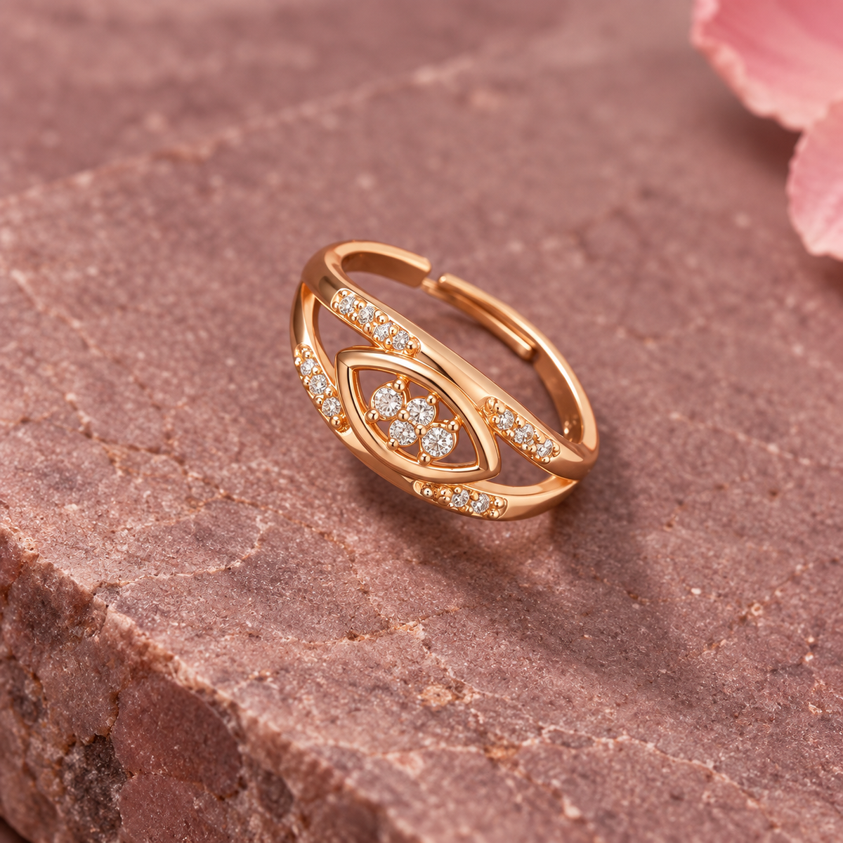 Naina Sparkle Rose Gold-Tone Crossover Ring on a mauve stone backdrop