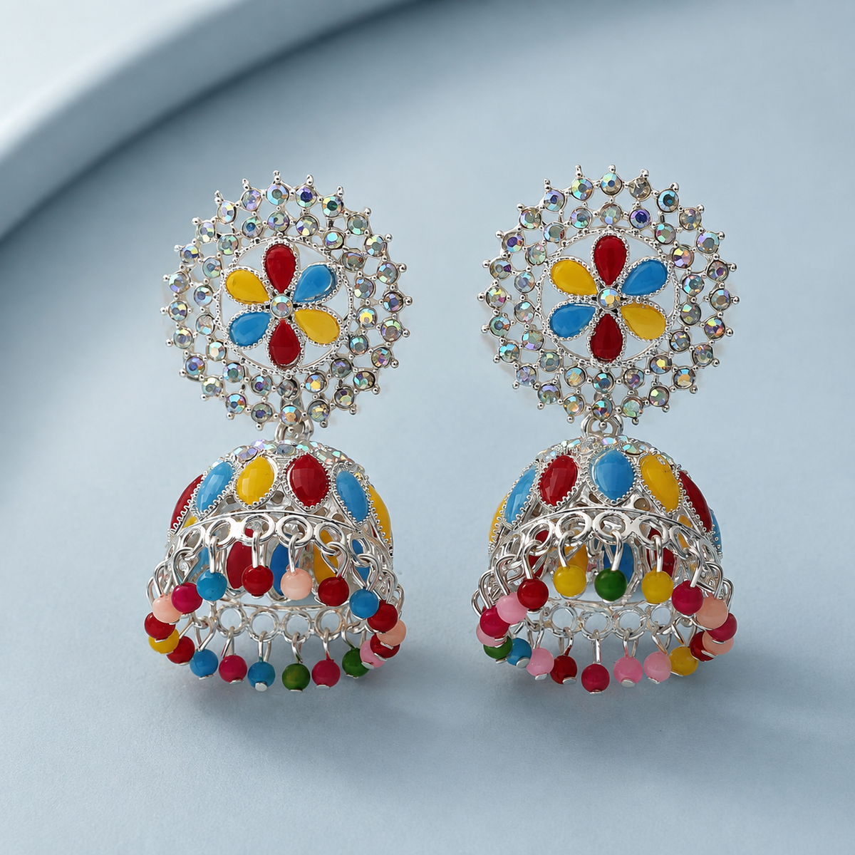 Rangoli Bloom Multicolour Jhumka Earrings – Silver-Tone Floral Design — styled flat lay