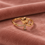 Titli Sparkle Butterfly Ribbon Rose Gold-Tone Ring on a dusty rose velvet backdrop