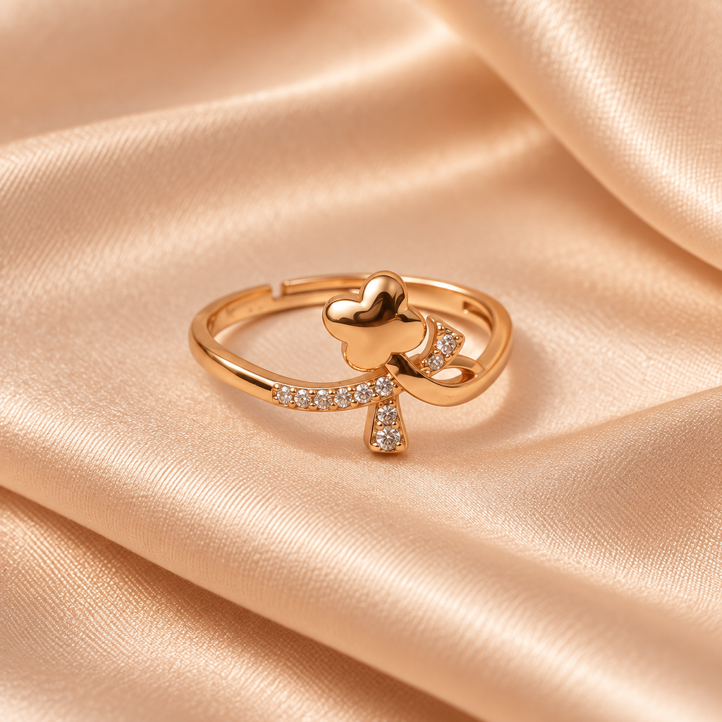 Titli Sparkle Butterfly Ribbon Rose Gold-Tone Ring on a champagne satin backdrop
